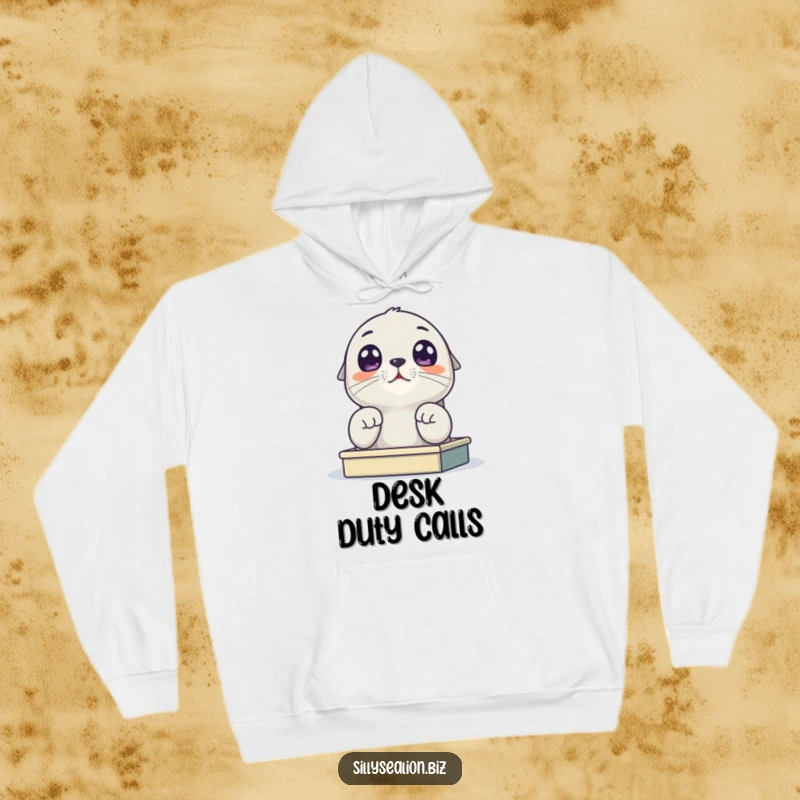 Funny sea lion pup hoodie showing a cute pup with large eyes peeking over a small desk, embodying relatable work-from-home energy.