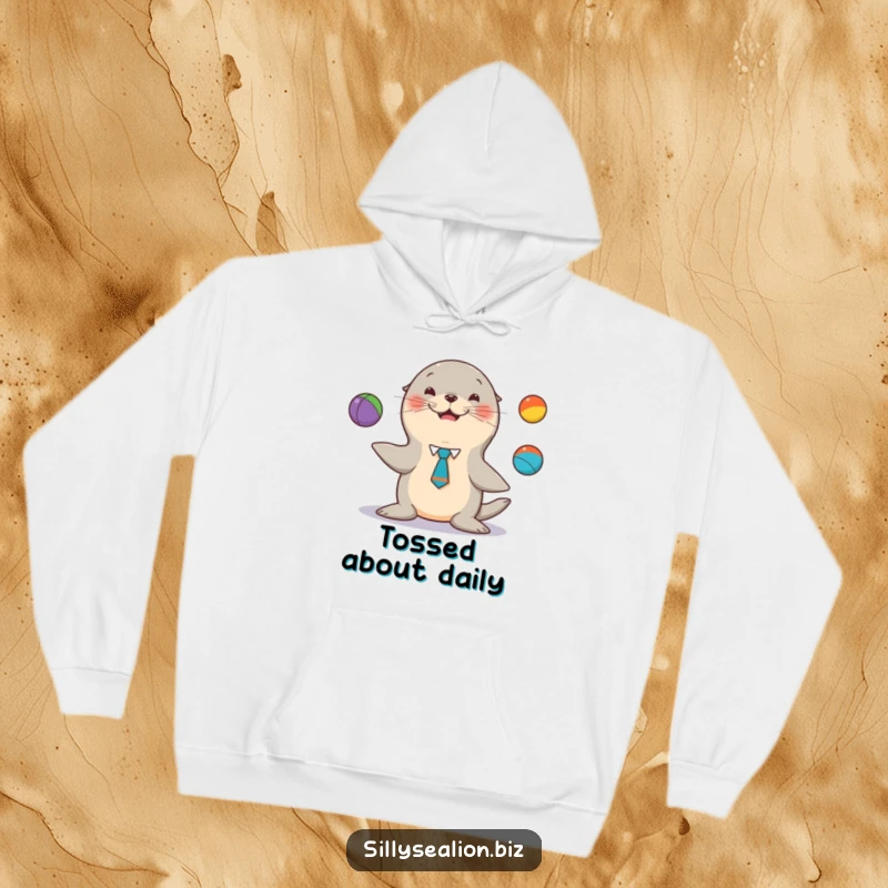 Funny sea lion hoodie, a tie, happily juggling colorful balls, for cozy, entertaining moments.